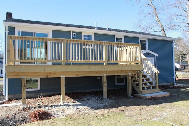 rear view of house featuring a wooden deck