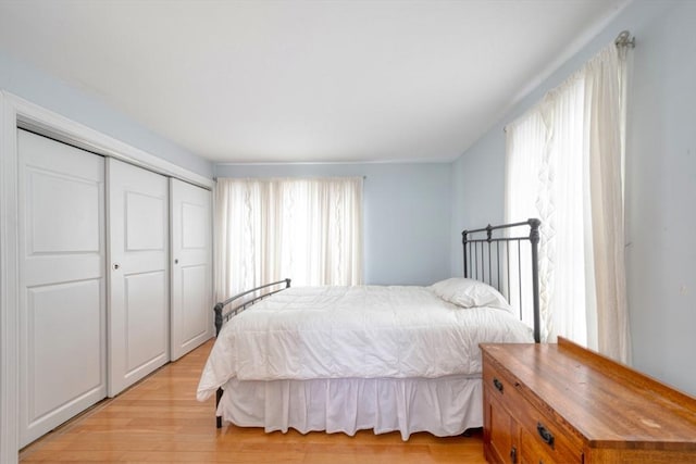 bedroom featuring light wood-type flooring and a closet