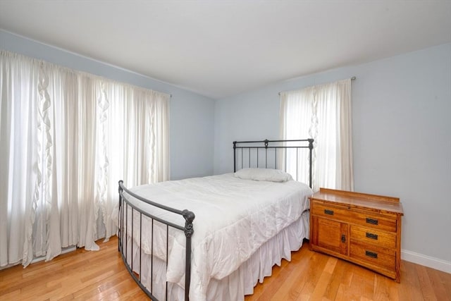 bedroom featuring light wood-style flooring and baseboards