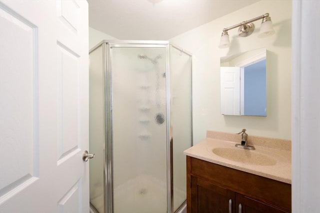 bathroom with vanity and a stall shower