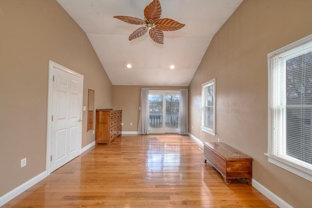 empty room with light wood-type flooring, recessed lighting, baseboards, ceiling fan, and vaulted ceiling