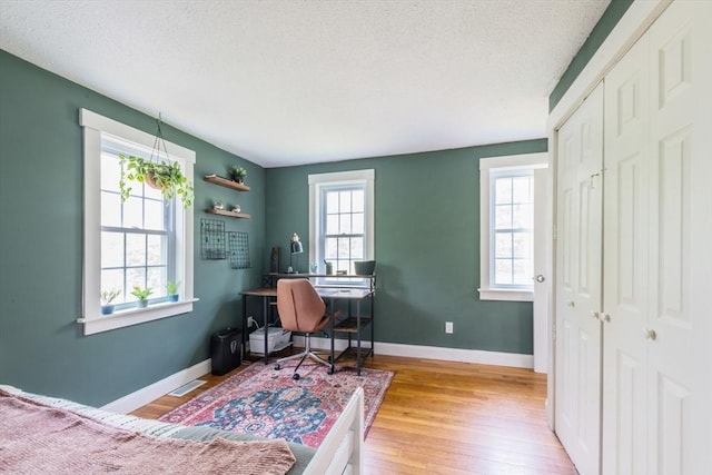 155 Great Marsh Rd, Barnstable, MA 02632 - home office featuring wood finished floors, a textured ceiling, and baseboards