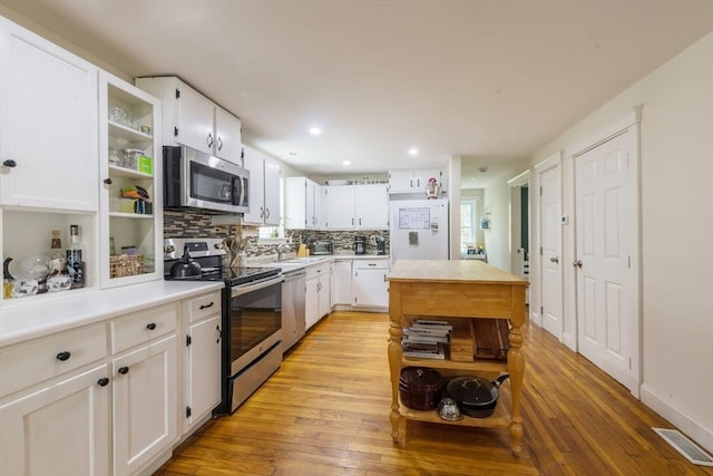 155 Great Marsh Rd, Barnstable, MA 02632 - kitchen with appliances with stainless steel finishes, open shelves, light wood-type flooring, and recessed lighting