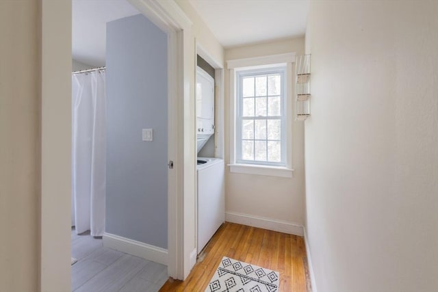 155 Great Marsh Rd, Barnstable, MA 02632 - corridor featuring estacked washer and dryer, light wood-style floors, and baseboards
