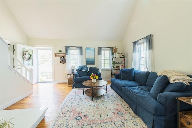 155 Great Marsh Rd, Barnstable, MA 02632 - living room featuring healthy amount of natural light, wood finished floors, baseboards, and high vaulted ceiling