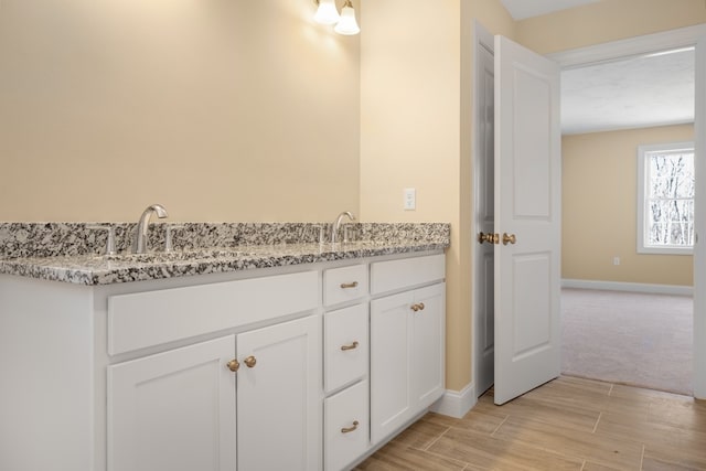 bathroom with vanity and hardwood / wood-style floors