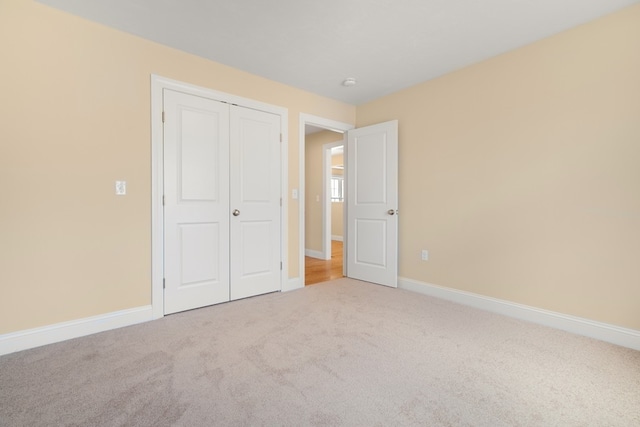 unfurnished bedroom with a closet and carpet