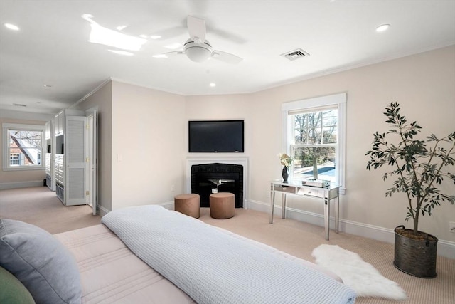 bedroom featuring visible vents, light carpet, and baseboards