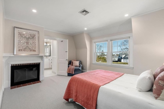 bedroom with recessed lighting, light colored carpet, visible vents, ornamental molding, and a fireplace with flush hearth