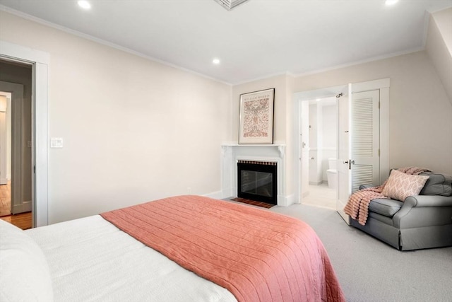 bedroom with ornamental molding, carpet flooring, a fireplace with flush hearth, and recessed lighting