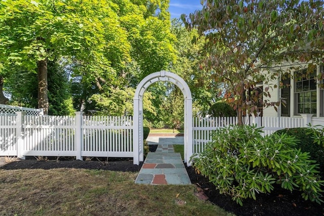 view of gate with a fenced front yard