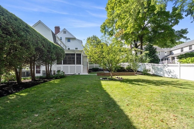 view of yard featuring a sunroom and fence