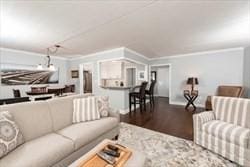 living room featuring hardwood / wood-style flooring and ornamental molding