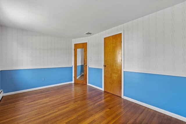 empty room with wood finished floors and baseboards