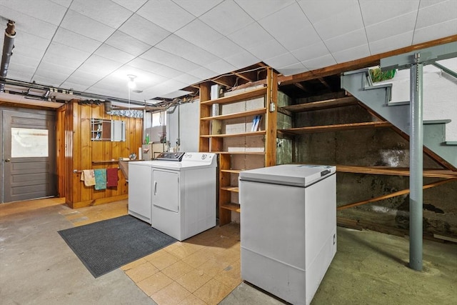 below grade area with separate washer and dryer, refrigerator, and stairs