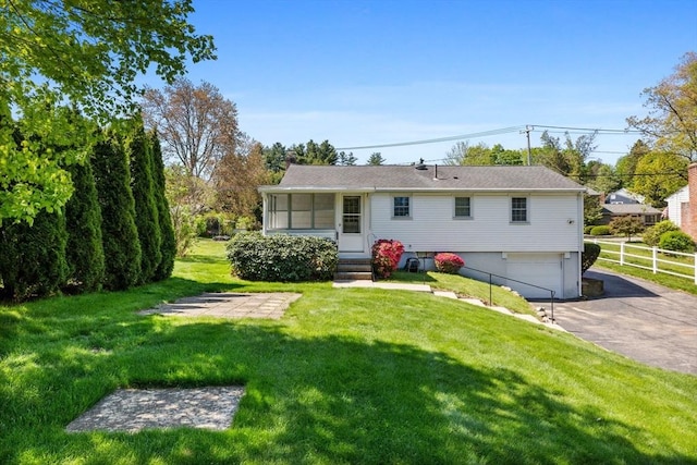 back of house featuring driveway, a garage, and entry steps