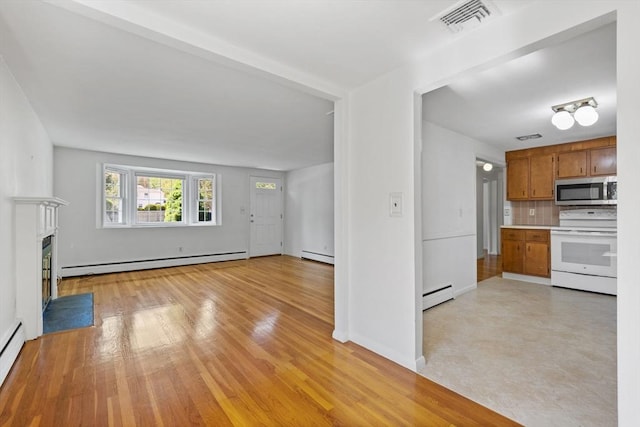 unfurnished living room with a baseboard radiator, a baseboard heating unit, a fireplace with flush hearth, and light wood-type flooring