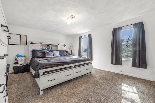 bedroom with a textured ceiling and baseboards