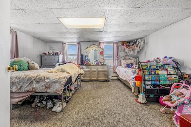 bedroom featuring carpet and a paneled ceiling