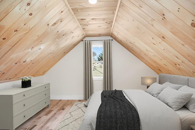 bedroom featuring lofted ceiling, light hardwood / wood-style floors, and wooden ceiling