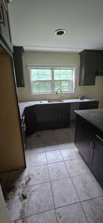 75 Downey Rd, North Brookfield, MA 01535 - kitchen featuring healthy amount of natural light, dark cabinets, and light tile patterned flooring