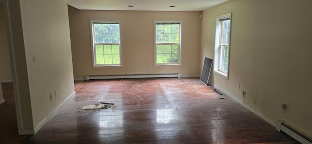 75 Downey Rd, North Brookfield, MA 01535 - empty room with baseboard heating, plenty of natural light, and wood finished floors