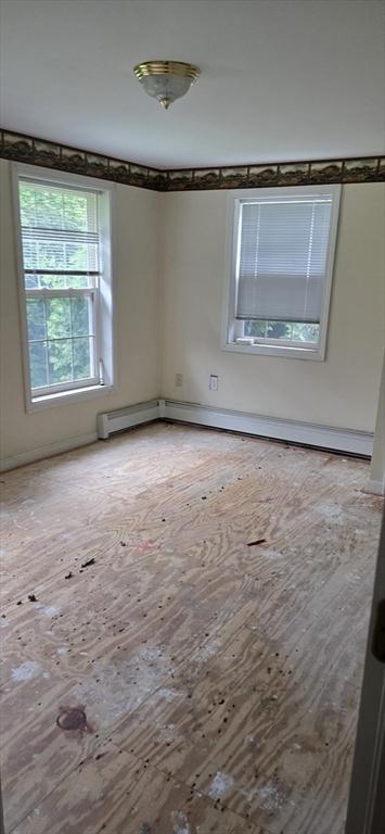 75 Downey Rd, North Brookfield, MA 01535 - empty room with wood-type flooring and a baseboard radiator