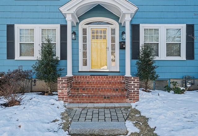 view of snow covered property entrance