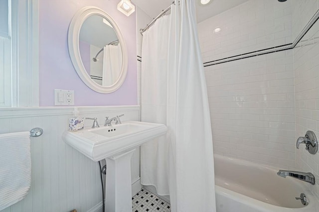 bathroom with tile patterned flooring and shower / tub combo