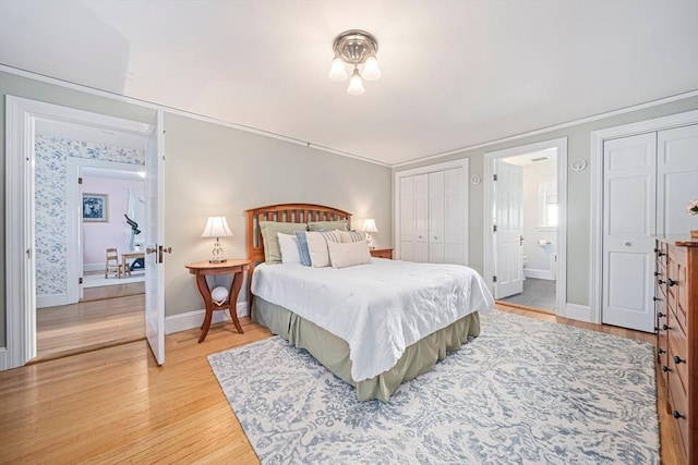 bedroom with ensuite bathroom, crown molding, and light hardwood / wood-style flooring