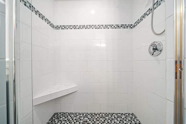 bathroom with tiled shower