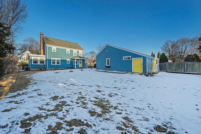 view of snow covered rear of property