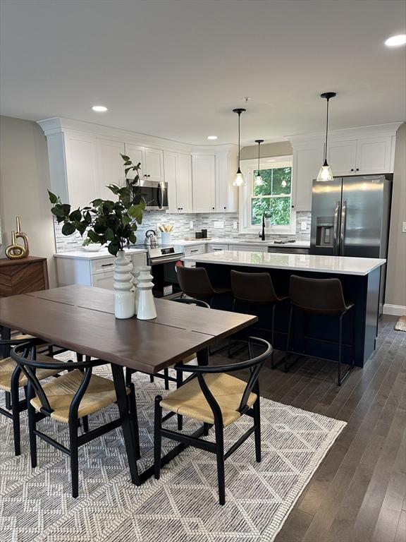 dining room with sink and hardwood / wood-style floors