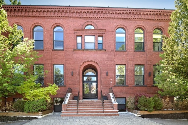 townhome / multi-family property with brick siding and french doors