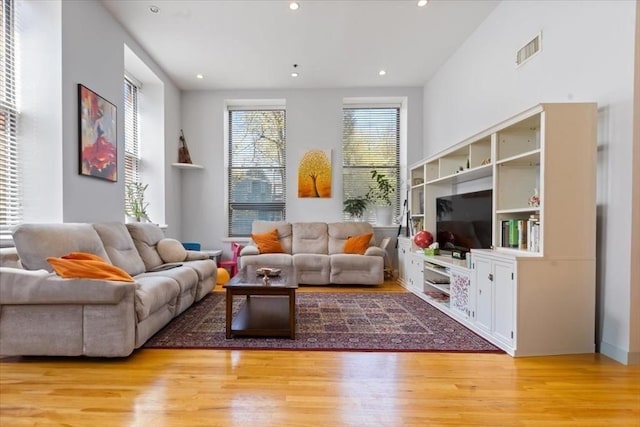 living area featuring light wood finished floors and recessed lighting