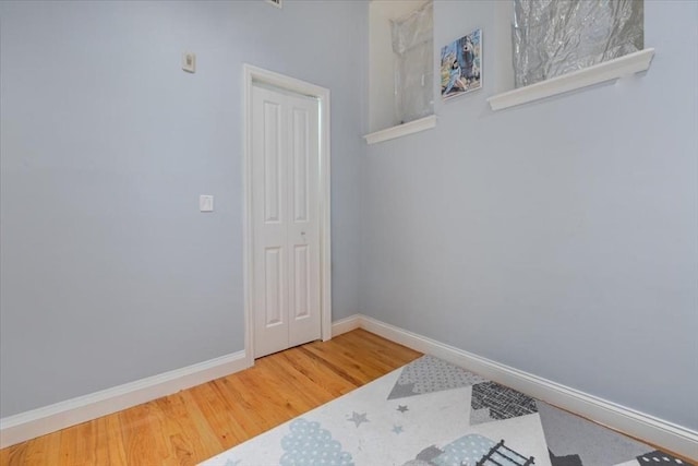 empty room with wood finished floors and baseboards