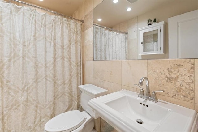 full bath with tile walls, a sink, backsplash, toilet, and recessed lighting
