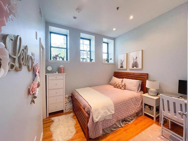 bedroom with wood finished floors and recessed lighting