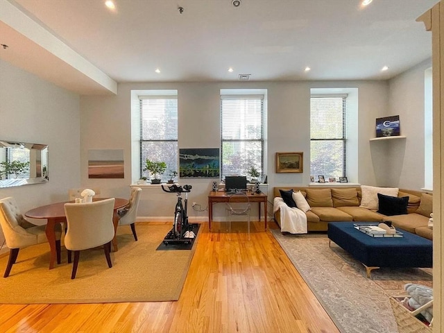 living area featuring wood finished floors, recessed lighting, plenty of natural light, and baseboards