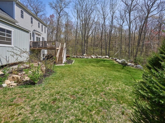 view of yard featuring stairs and a wooden deck