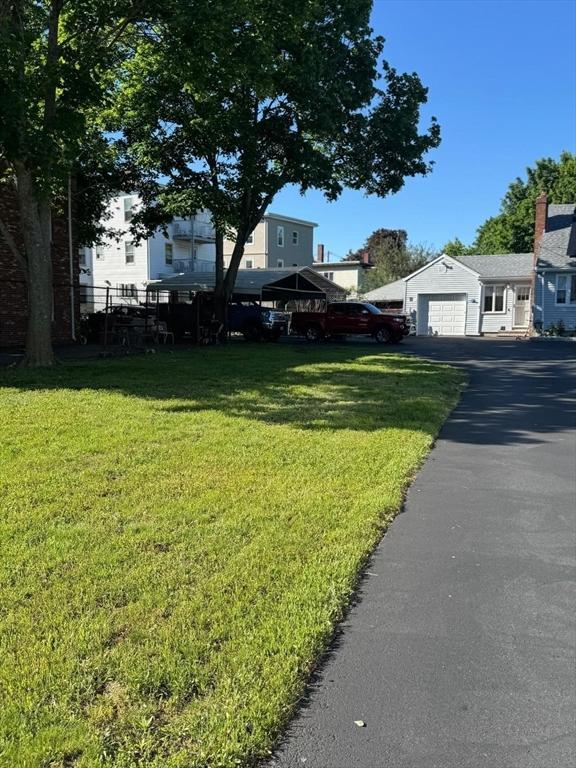 335 Euclid Ave, Lynn, MA 01904 - view of front facade featuring asphalt driveway and a front lawn