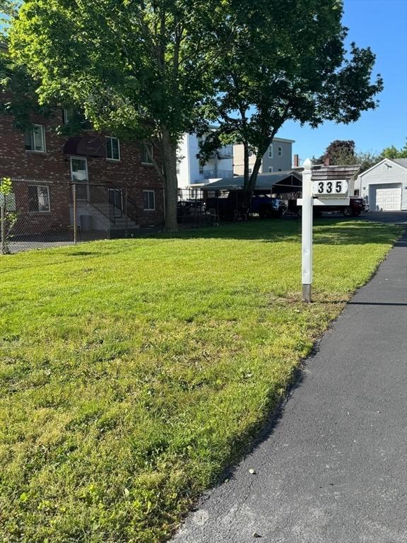 335 Euclid Ave, Lynn, MA 01904 - view of grassy yard featuring a detached garage