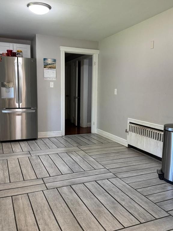 335 Euclid Ave, Lynn, MA 01904 - kitchen featuring stainless steel fridge with ice dispenser, radiator, light wood-style flooring, and baseboards