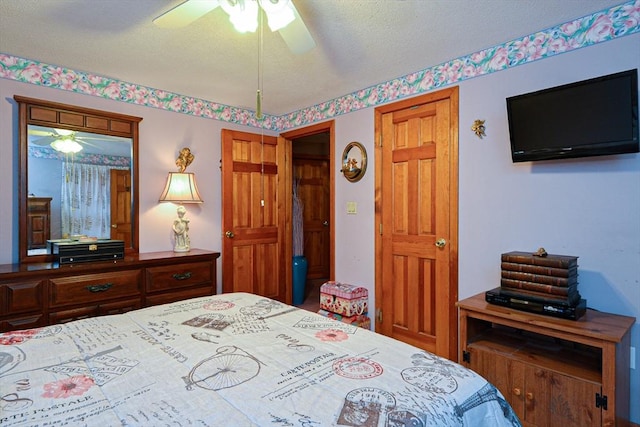 bedroom featuring a textured ceiling and ceiling fan