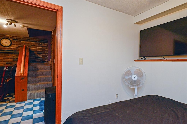 bedroom featuring a textured ceiling and tile patterned floors