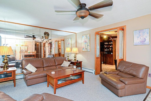 carpeted living room featuring ceiling fan, baseboard heating, and baseboards