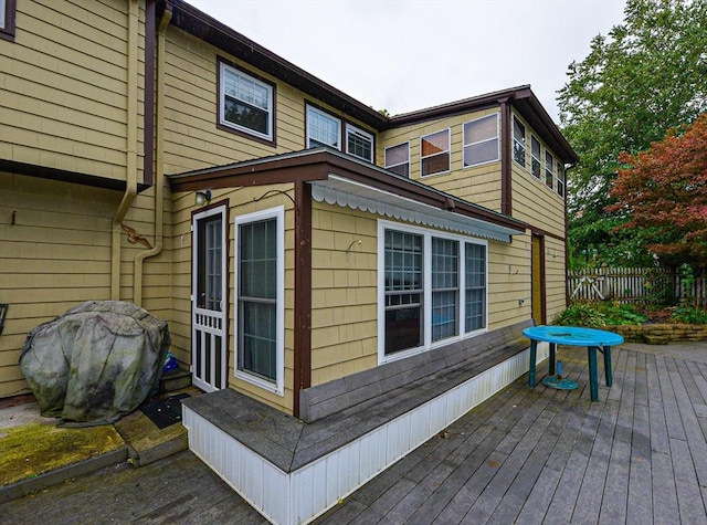 view of property exterior featuring a wooden deck and fence