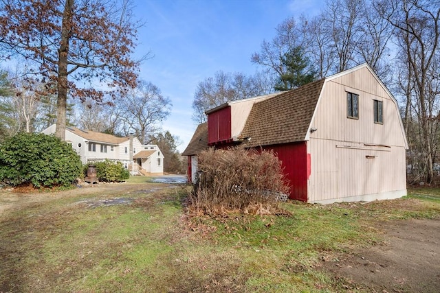 view of home's exterior with an outdoor structure