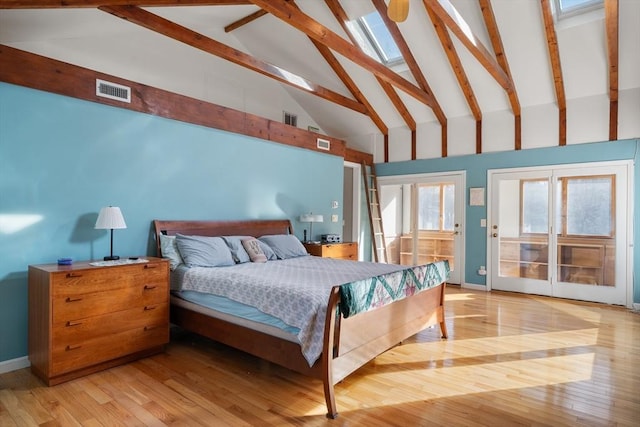 bedroom with light hardwood / wood-style floors, beam ceiling, and high vaulted ceiling