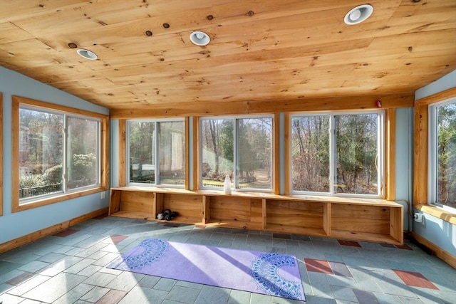 unfurnished sunroom featuring lofted ceiling and wooden ceiling